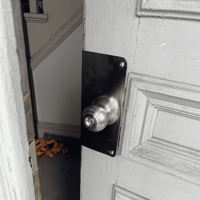 Silver door knob on a white door.