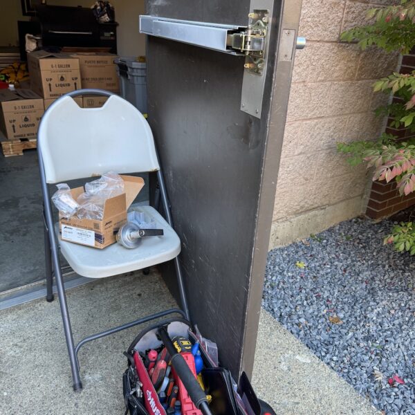 A chair and bag of tools are outside.