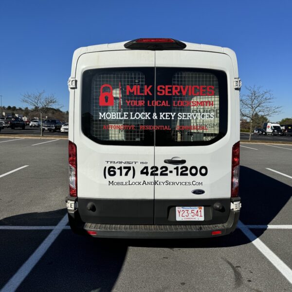 A white transit van parked in the middle of a parking lot.