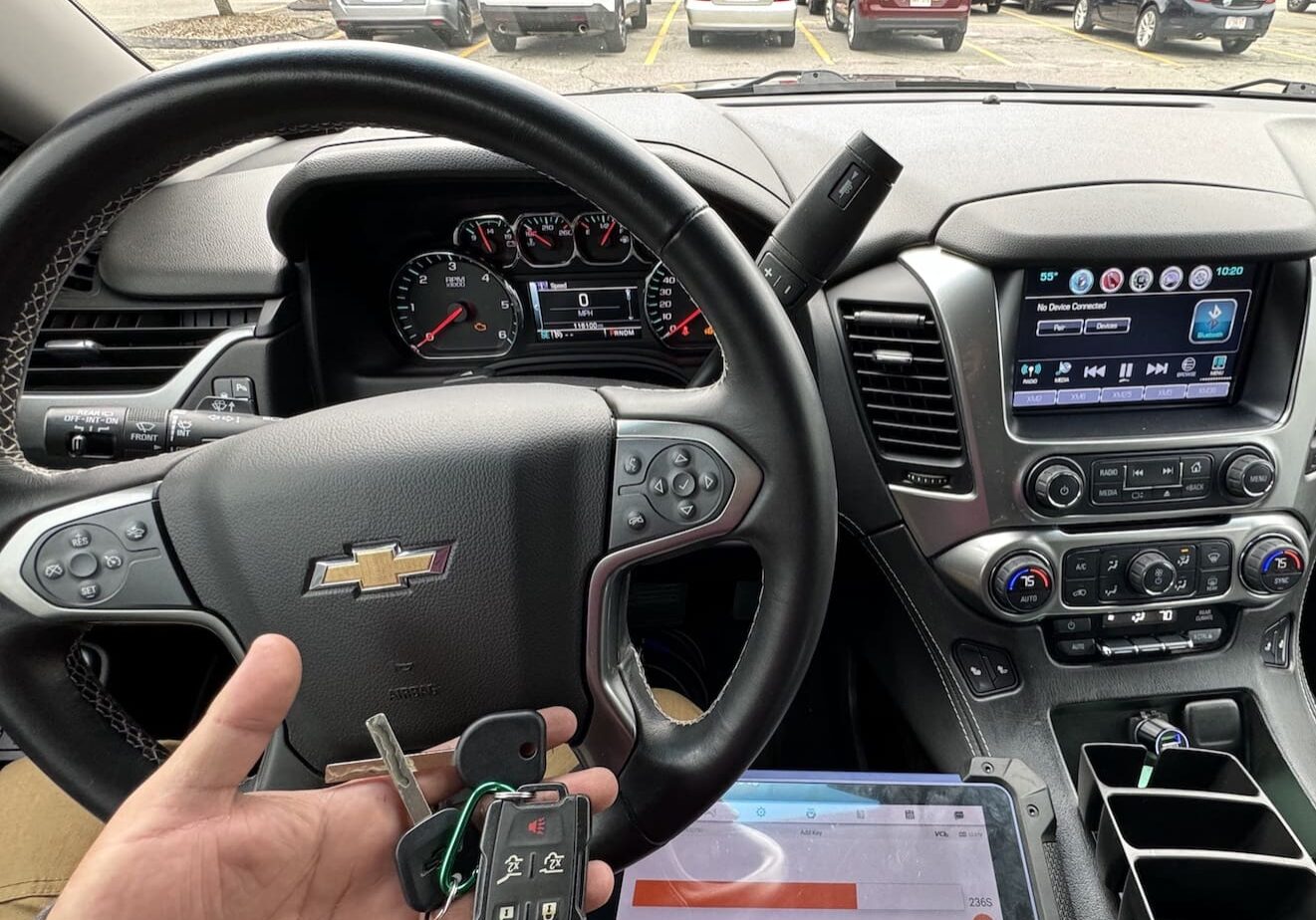 A person holding a remote in their hand while driving.