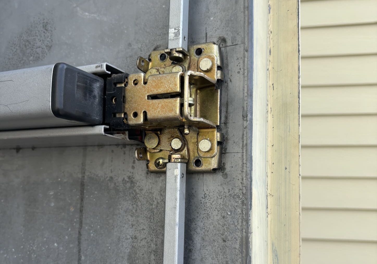 A garage door has been locked up and is open.