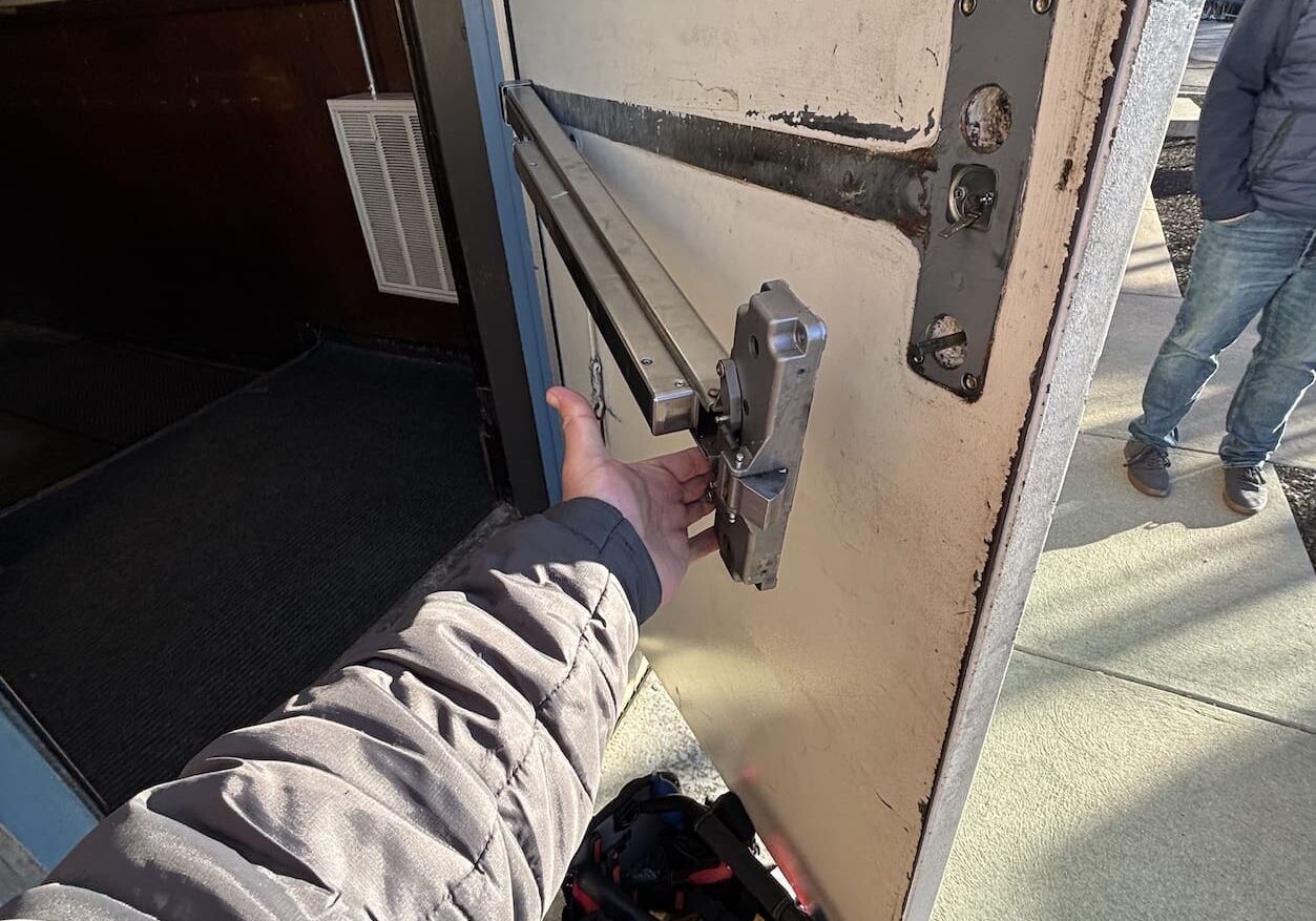 Person fixing door lock mechanism.