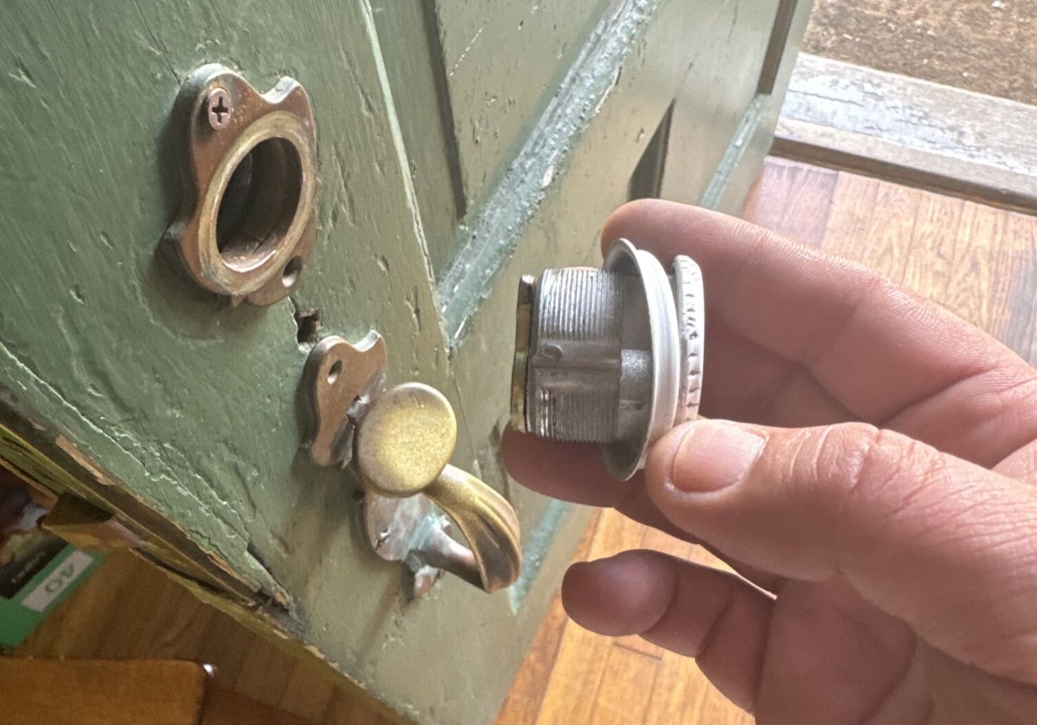 A person holding a key to the door of their home.